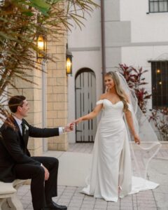 A stunning bride and groom standing together, gazing into each other’s eyes with love.