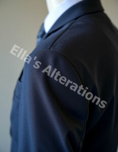 Tailor checking shoulder fit06_17_2026